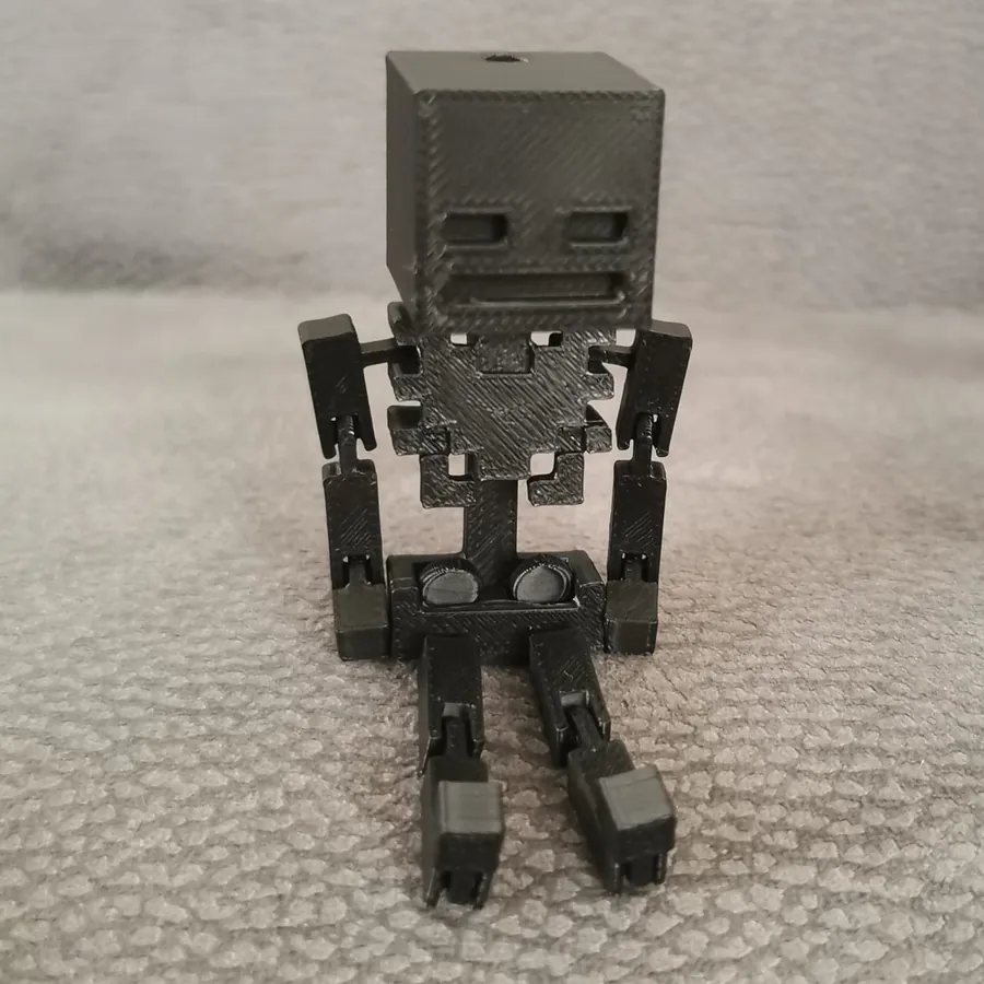 A black 3D-printed skeleton with moving arms and legs