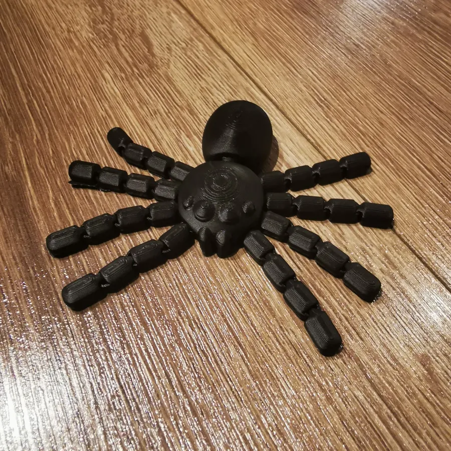 A black 3D-printed spider with jointed legs