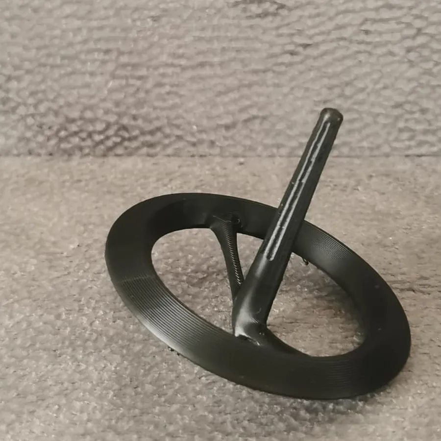 A black 3D-printed spinning top